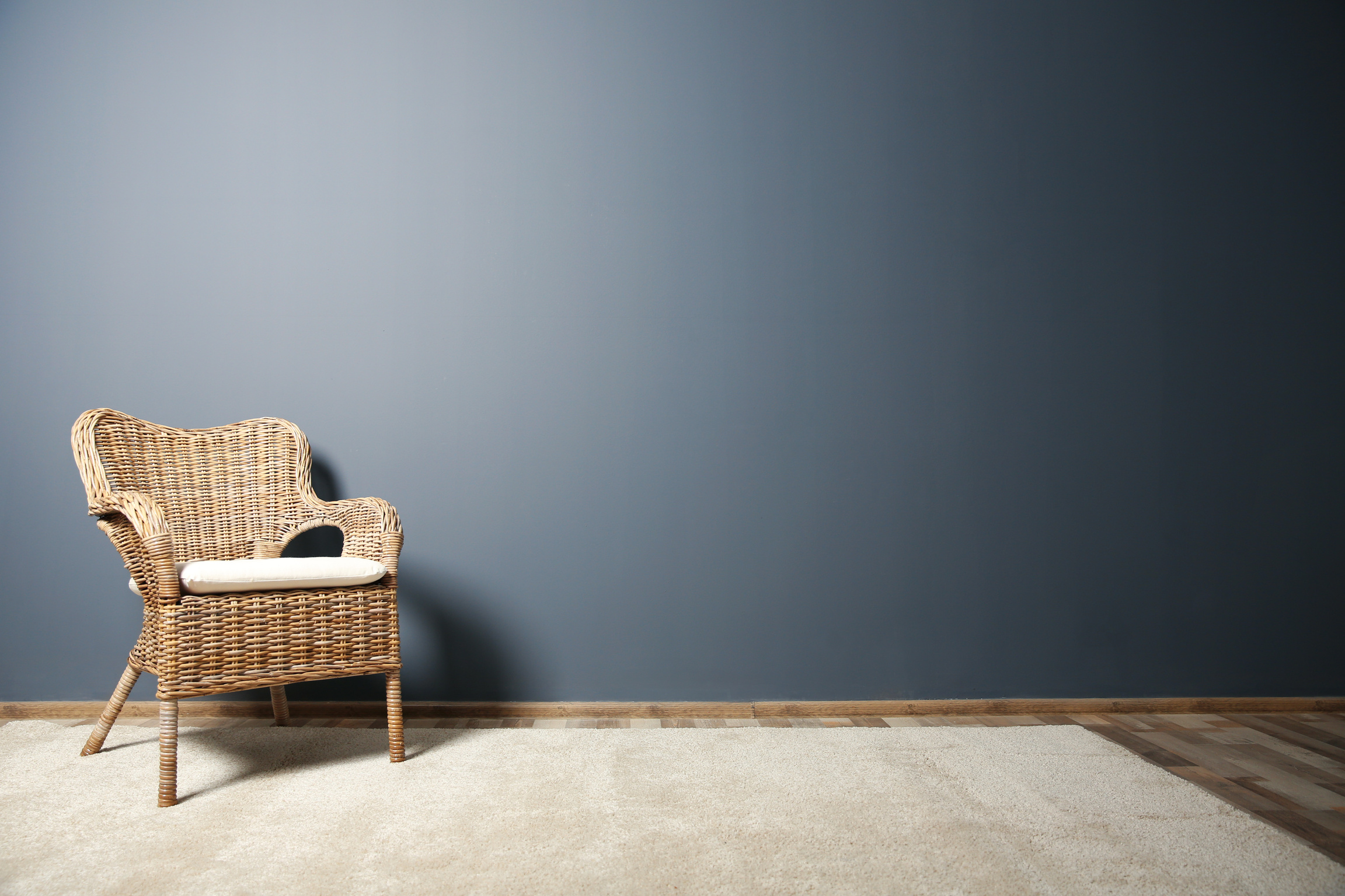 Wicker Chair on Dark Grey Wall Background